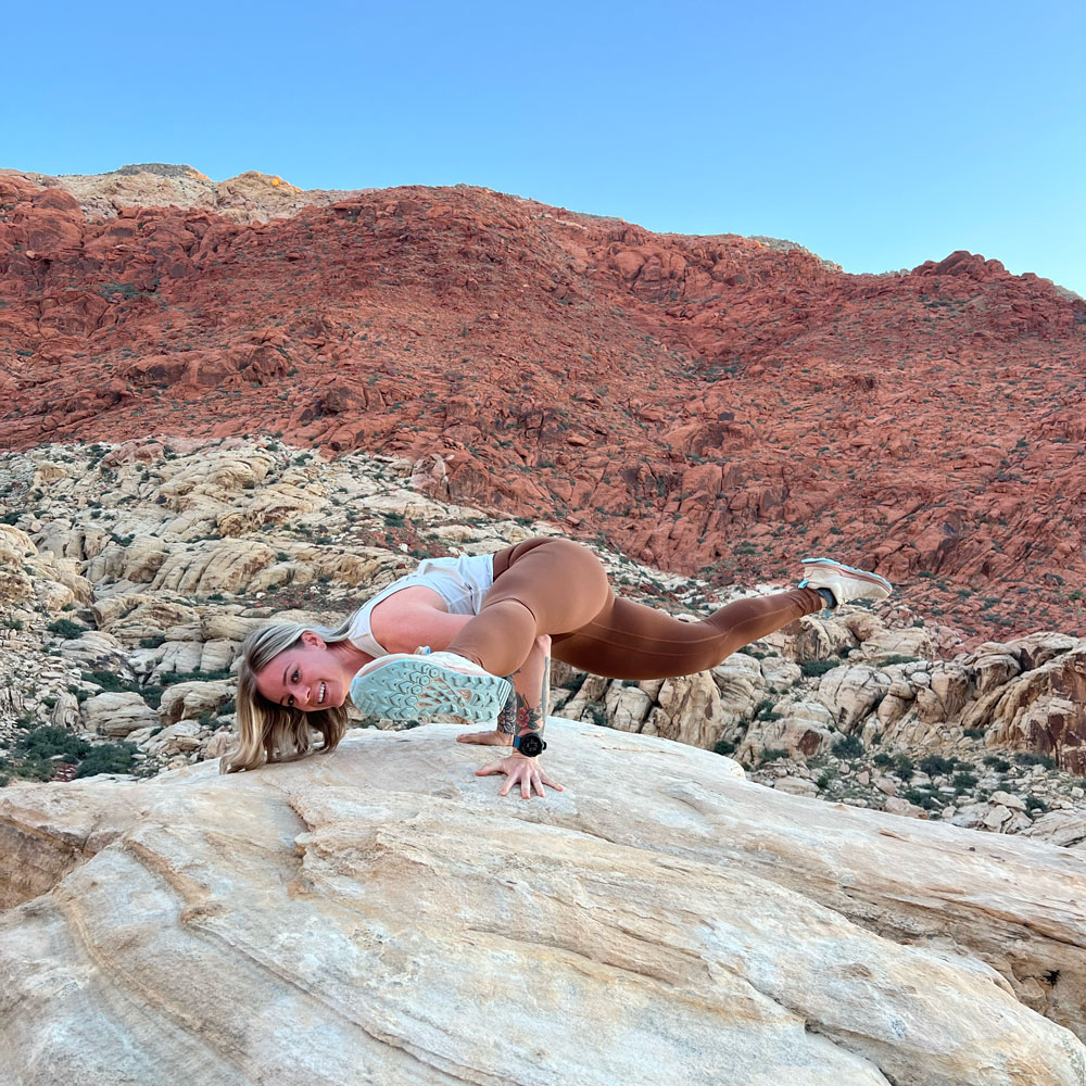The coach is posing with canyon background.